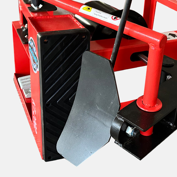 Red and black mechanical device with a lever on a white background